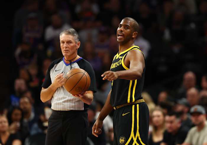 Referee Scott Foster and Warriors guard Chris Paul during Golden State's game against the Suns on Nov. 22, 2023.